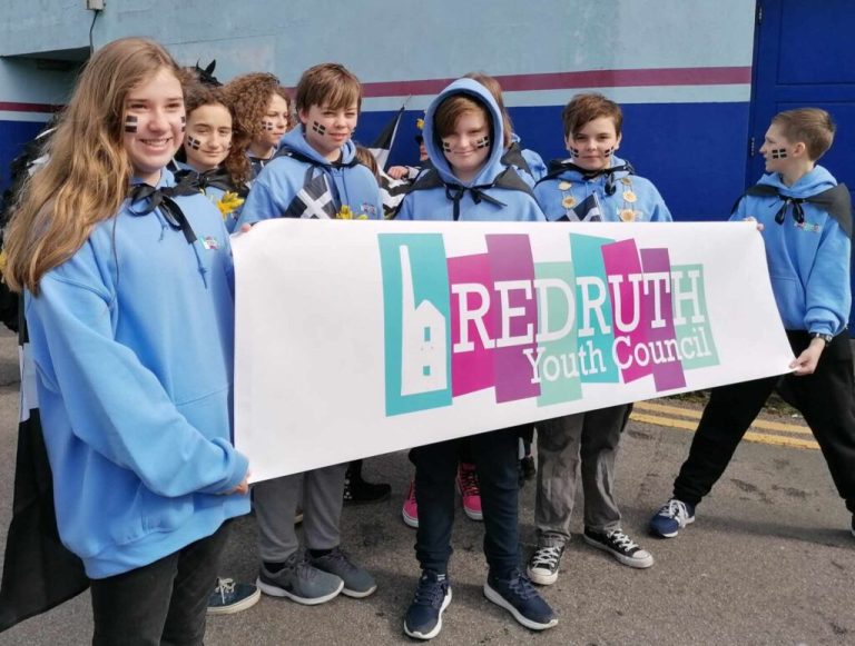 Redruth Youth Council members holding their banner